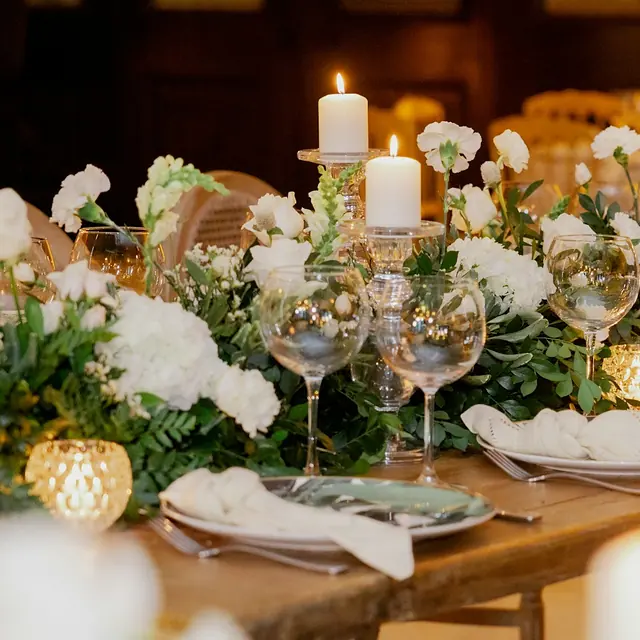 Candlelit table with white florals and gold votives